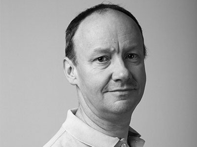 Head and shoulders portrait of David Newman looking to camera