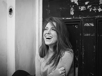 black and white photo of mary bevan laughing