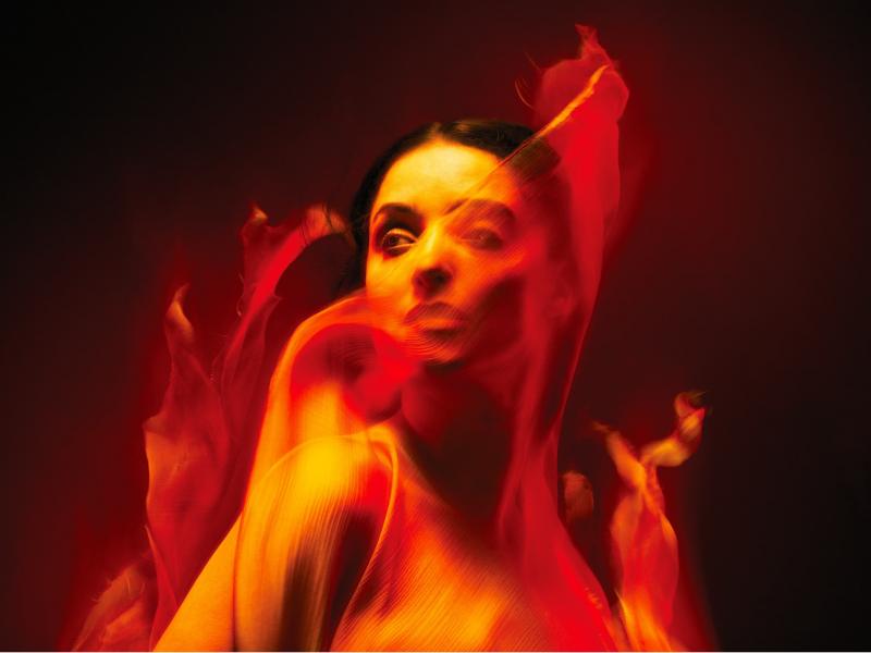 Woman in red flames for ENO's Norma
