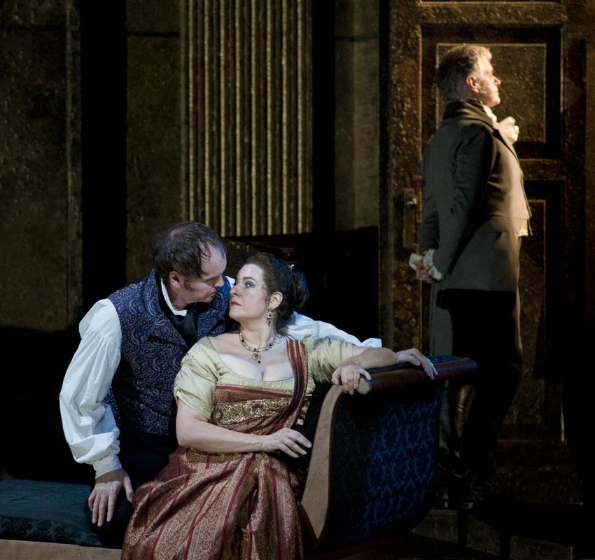 Tosca sat on the sofa with a man sitting behind