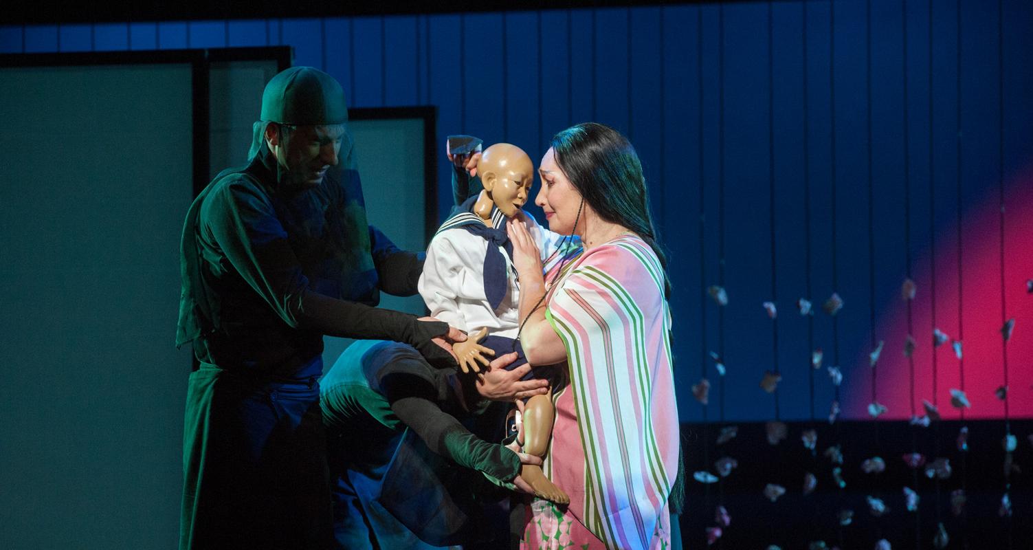 woman holding toy child in ENO's Madam Butterfly