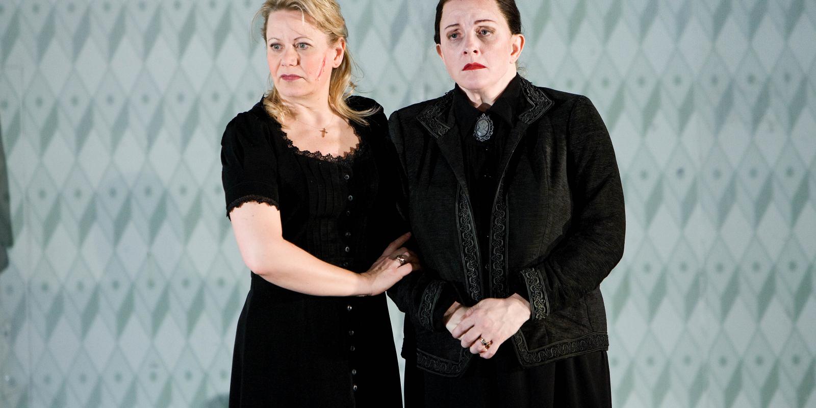 two women in grieving close interlocking arms in Jenufa