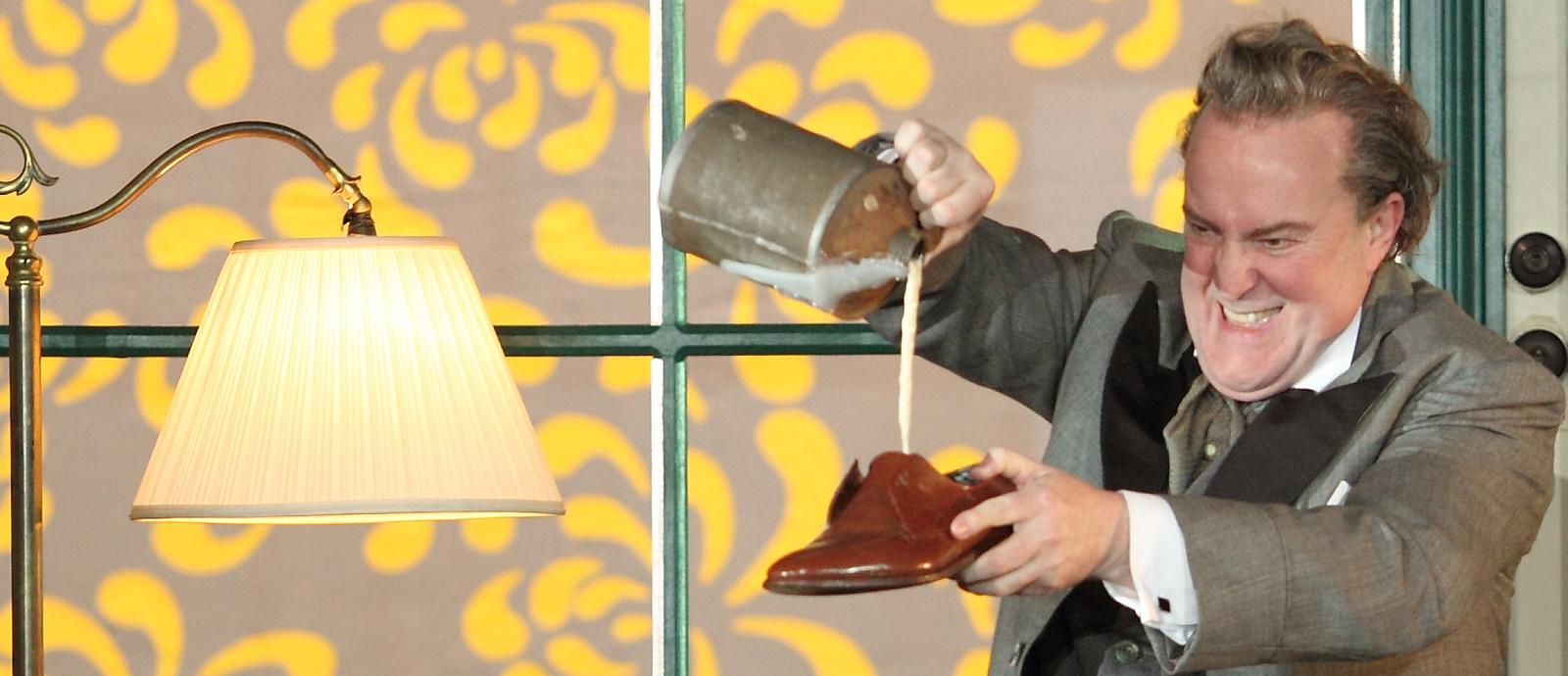 a man pouring beer into a shoe