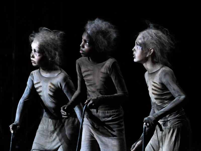 Three young children dressed as skeletons in the Magic Flute