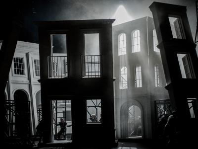 staging of five sides of a building on stage