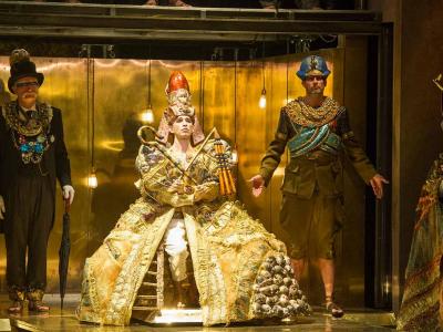 characters from akhnaten on stage in gold outfits