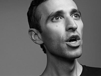 Anthony Roth Costanzo looking up and away from camera