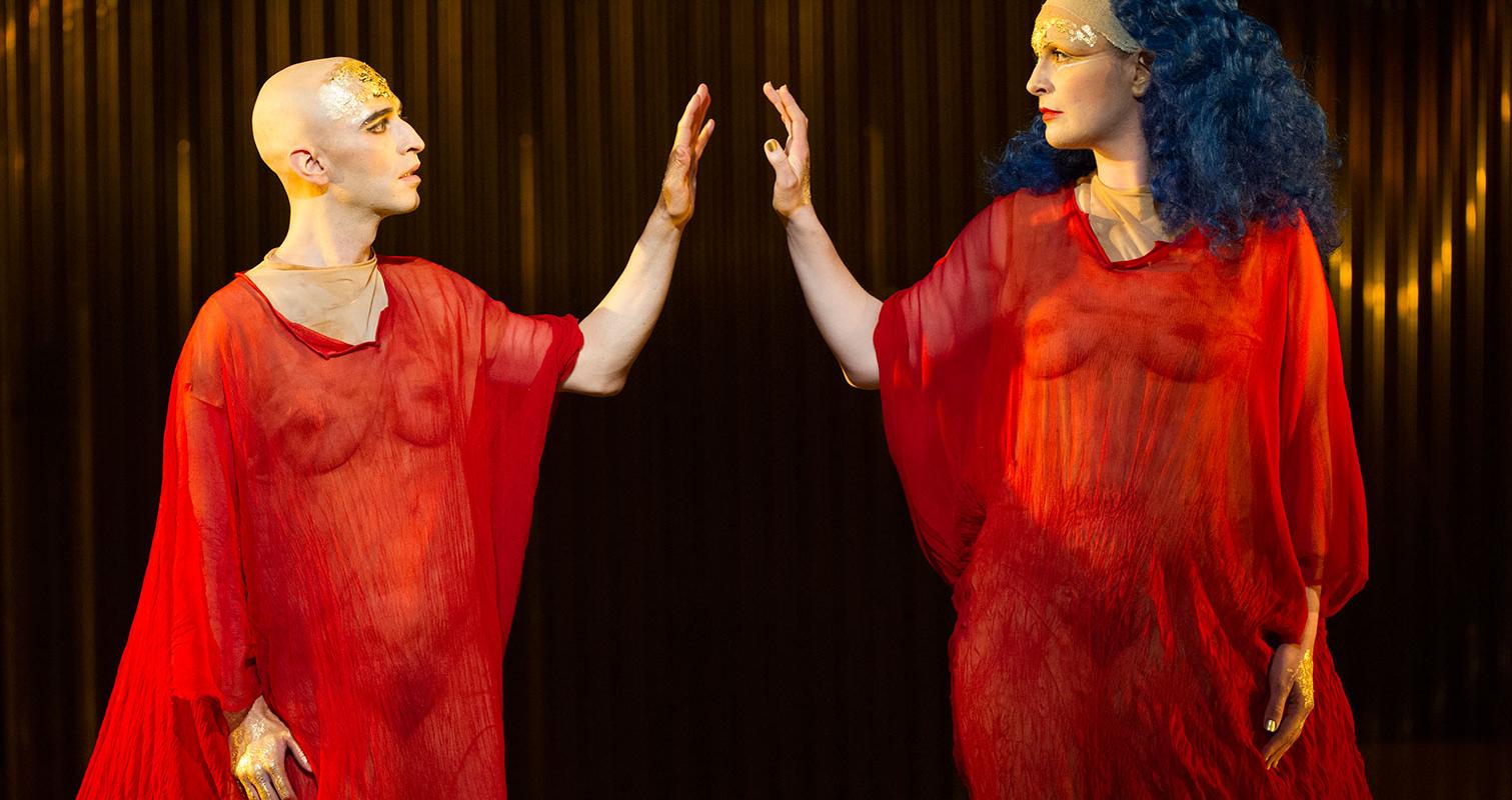 Akhnaten: two people in red robes