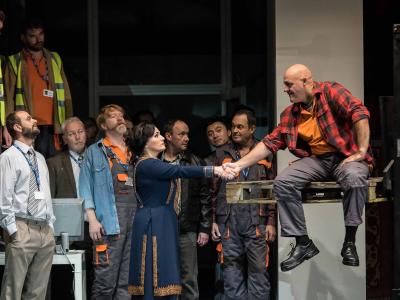 patricia racette as lady macbeth on stage with builders shaking their hand