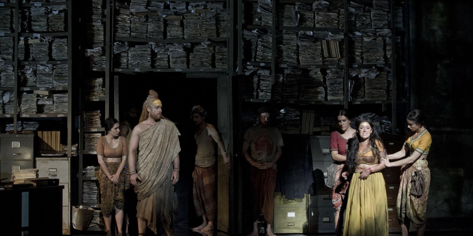 Cast of The Pearl Fishers in office scene surrounded by paperwork
