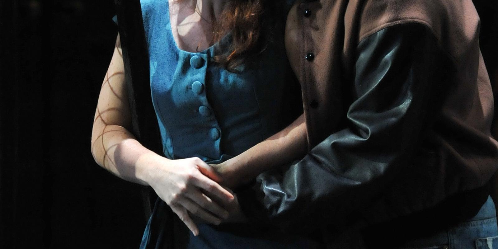 Actors on stage of Rigoletto embracing