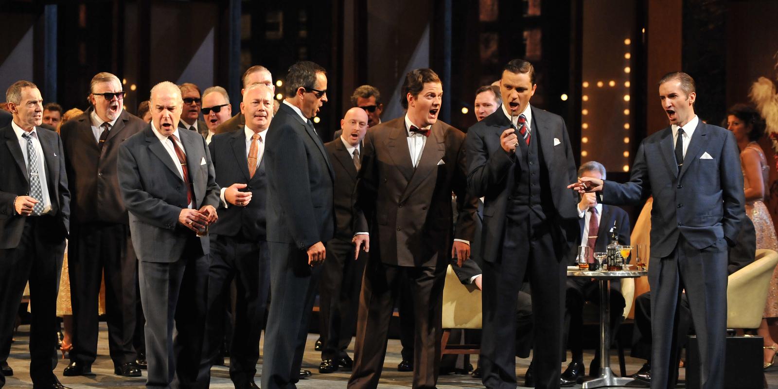 male chorus singing onstage of Rigoletto