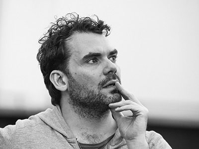 Daniel Kramer black and white portrait looking away from camera off to right