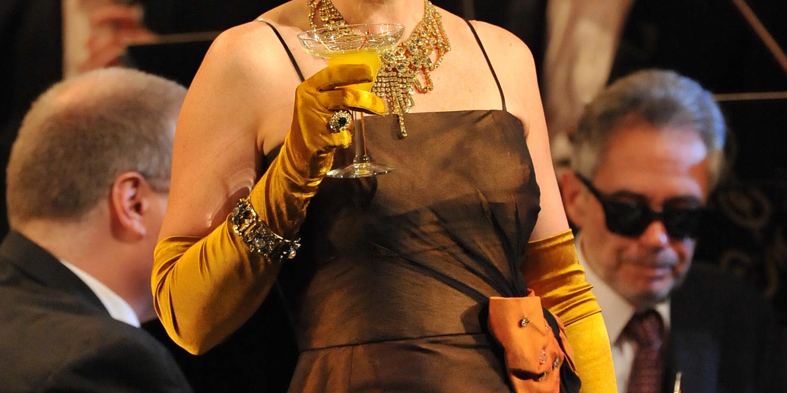 Rigoletto's Fiona Canfield's gold glove holding a martini glass