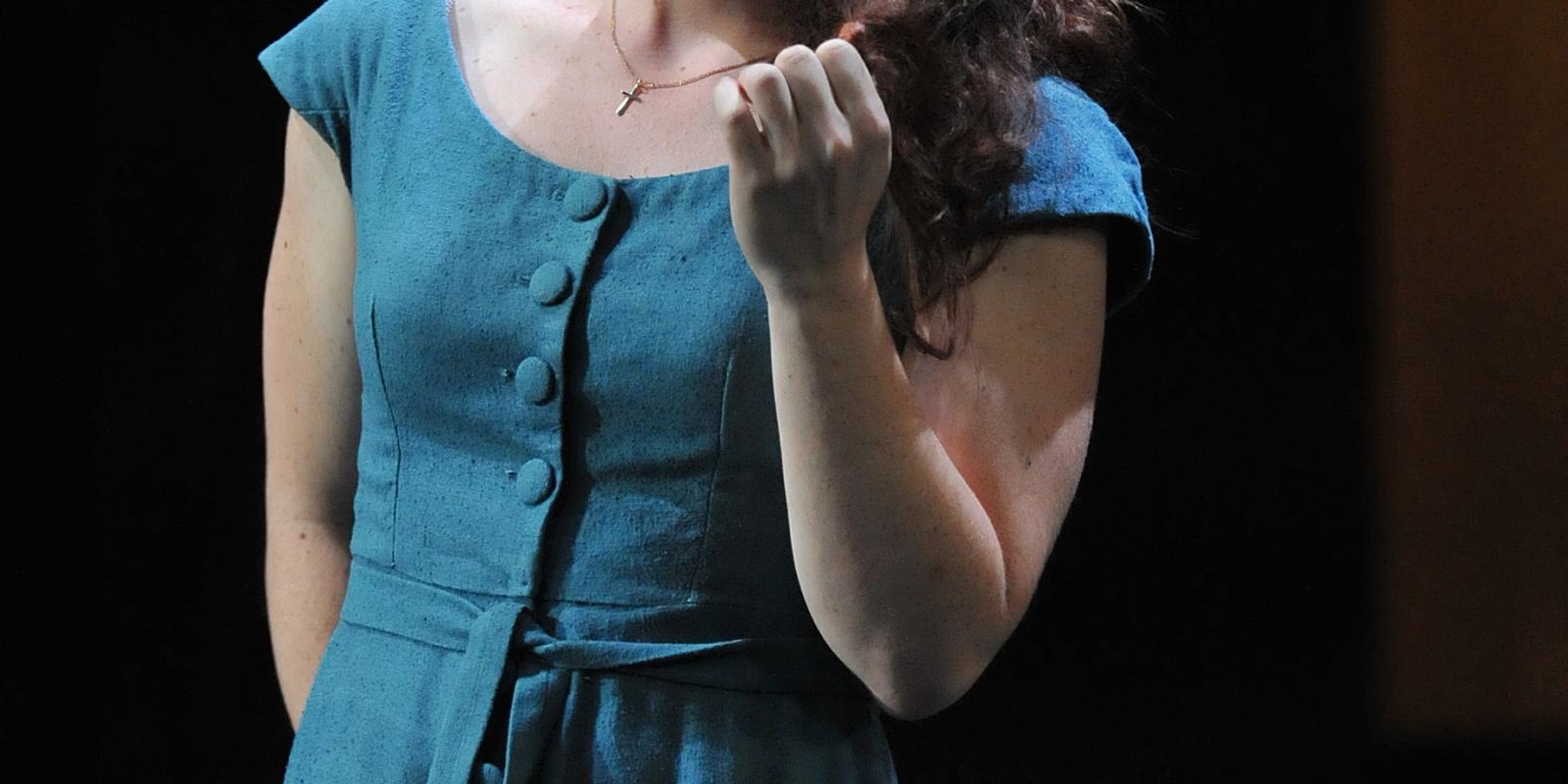 woman in blue dress performing on stage in Rigoletto