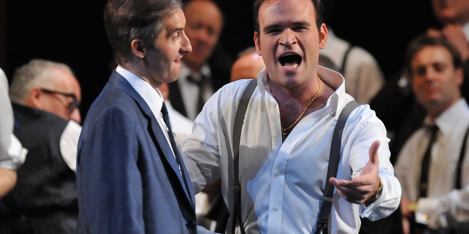 characters in suits and suspender belts performing on stage in Rigoletto