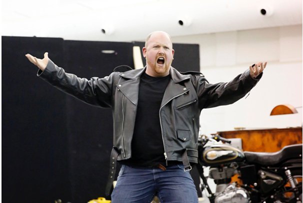 man in black leather jacket rehearsing backstage of Jenufa