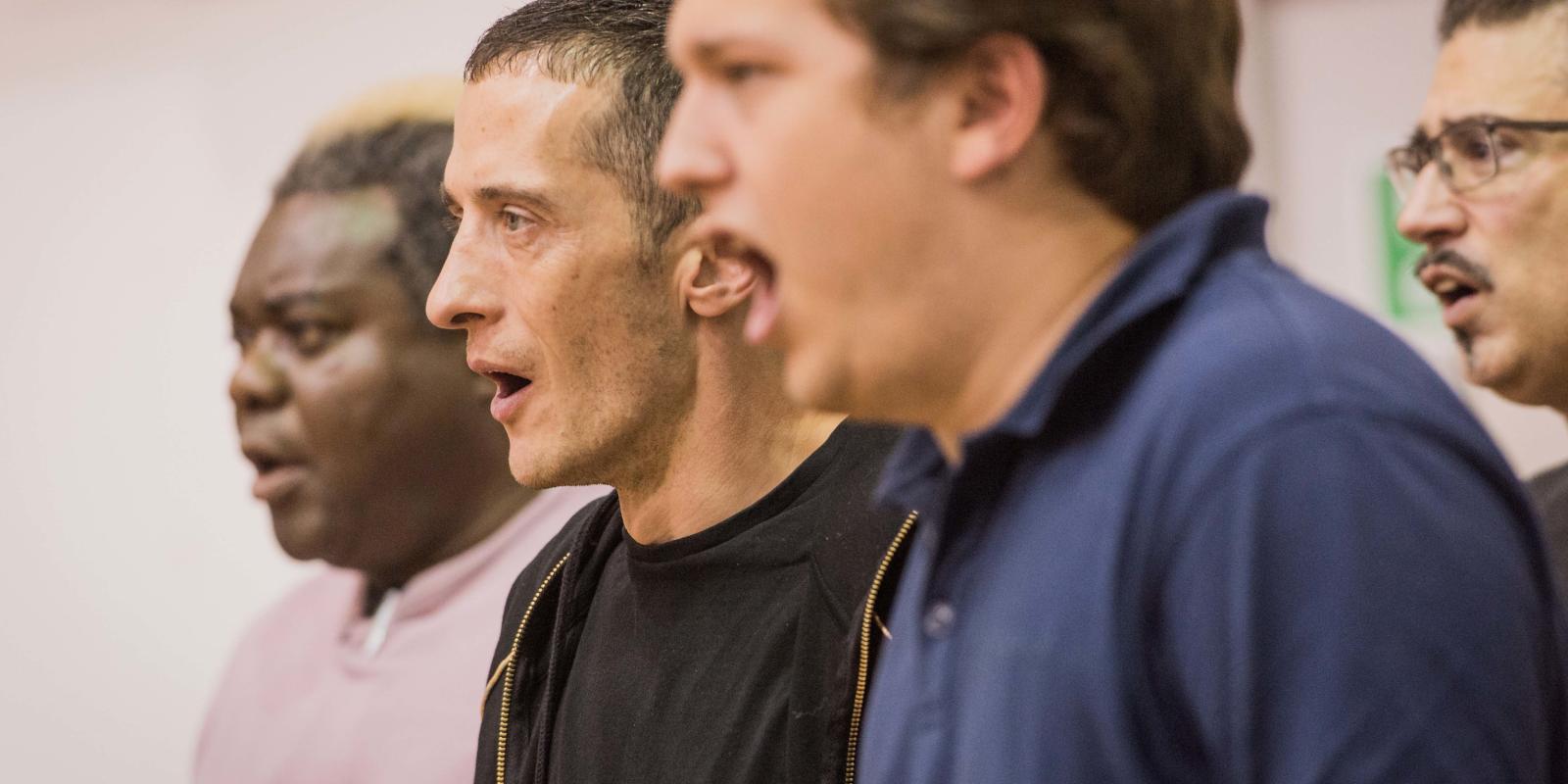 close up of men singing as part of Don Giovanni project