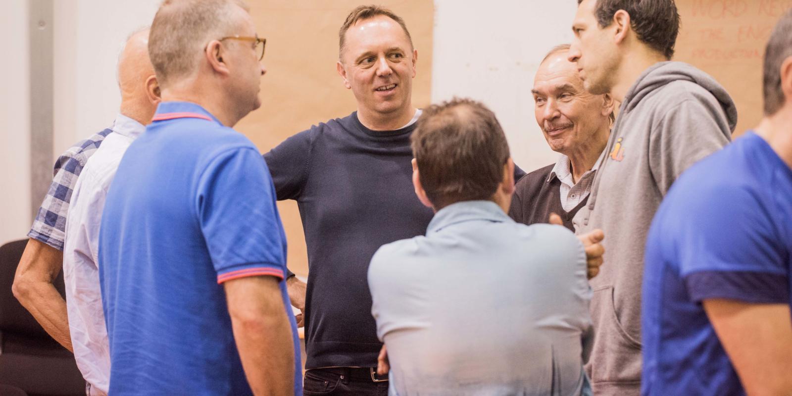 Group of men talking at Don Giovanni rehearsals