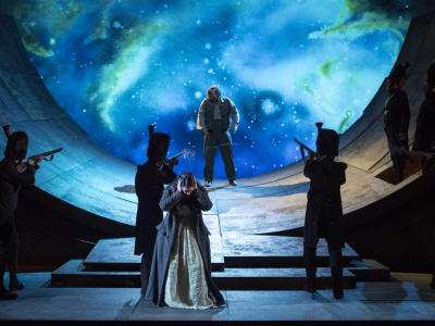 Soldiers firing at Cavaradossi as Tosca looks away