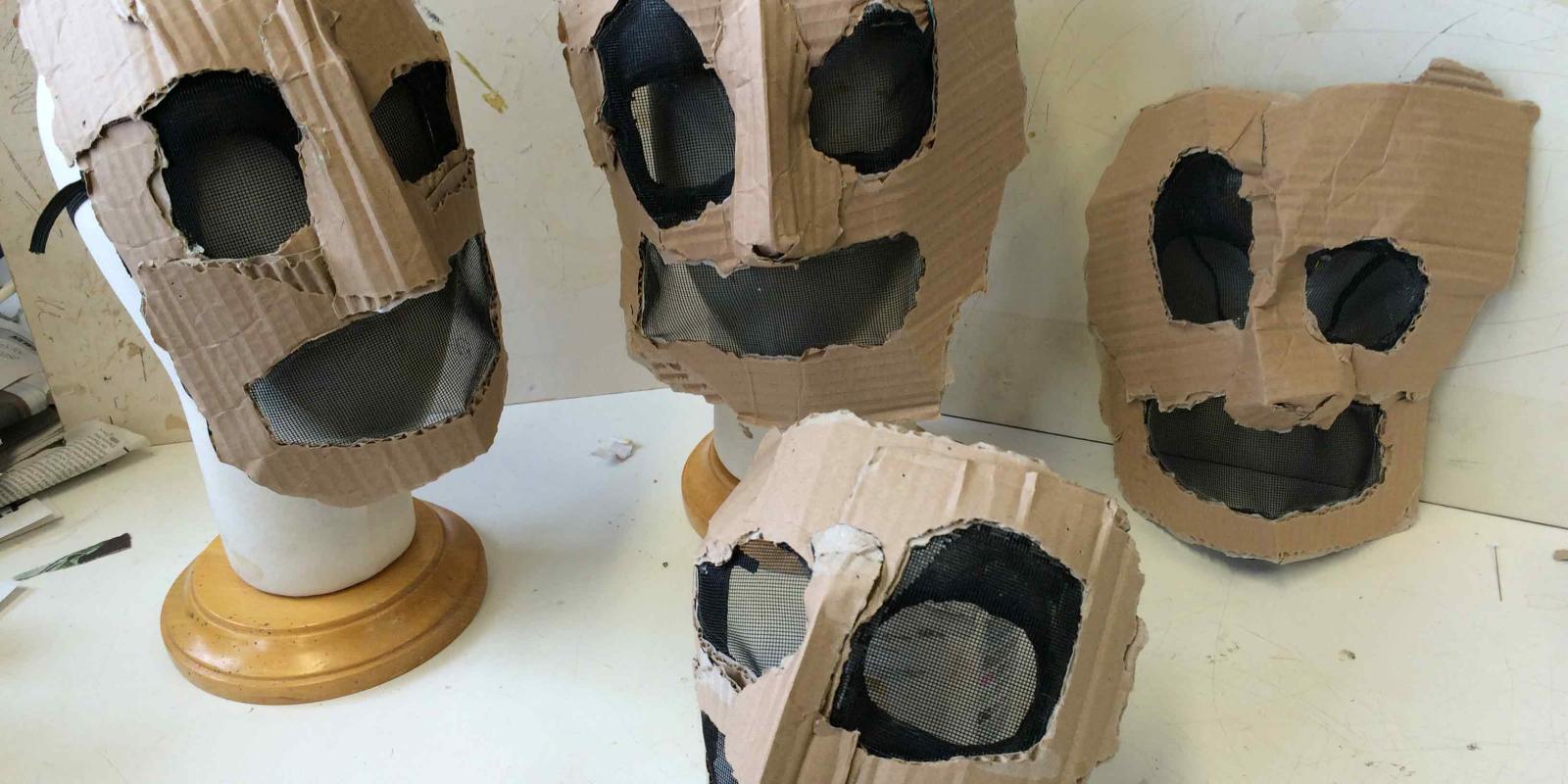 collection of four cardboard masks from Don Giovanni