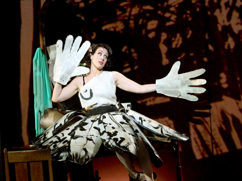 woman in black and white costume on stage of Lulu wearing giant white gloves