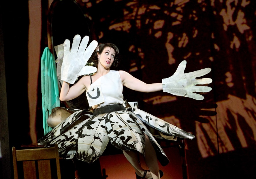 woman in black and white costume on stage of Lulu wearing giant white gloves