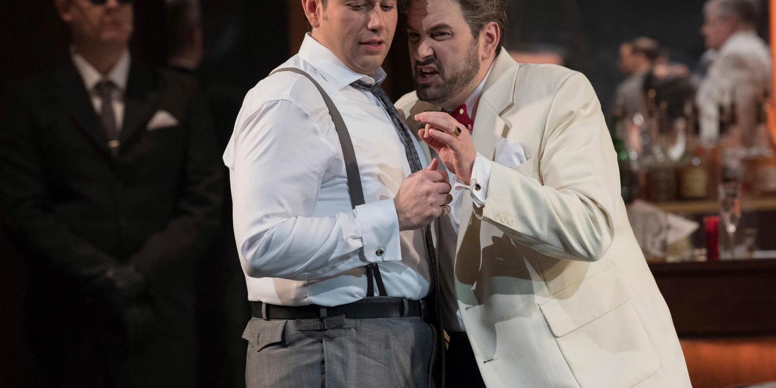 close up of two men in suits from ENO's Rigoletto