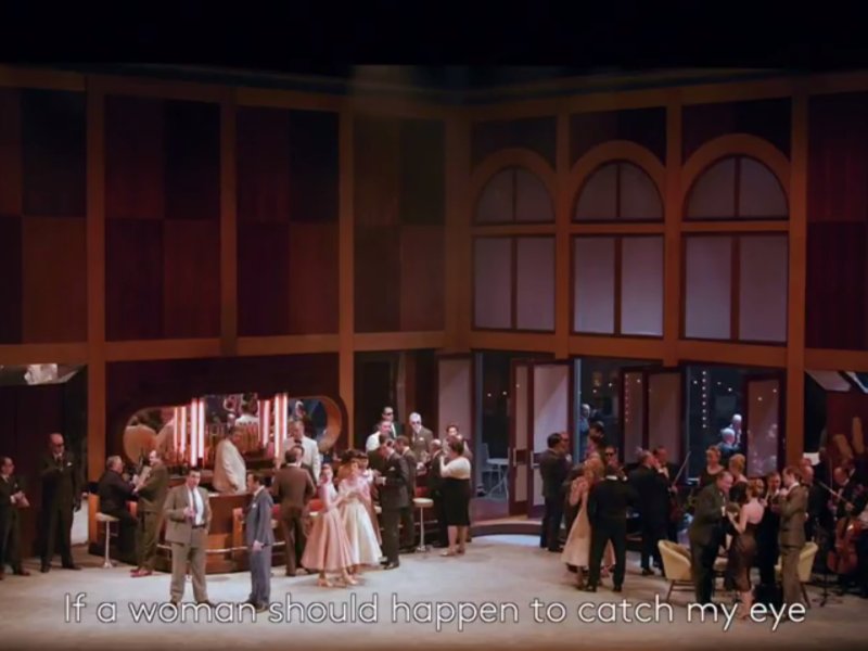 cast of Rigoletto on stage with subtitle reading if a woman should happen to catch my eye