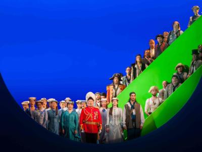 round image of cast from pirates of penzance on stage