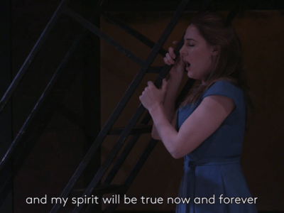 woman in blue dress with subtitles reading and my spirit will be true now and forever from Rigoletto