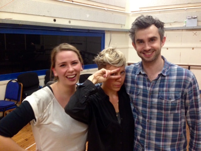 man and woman posing with a woman doing a peace sign by her eyes