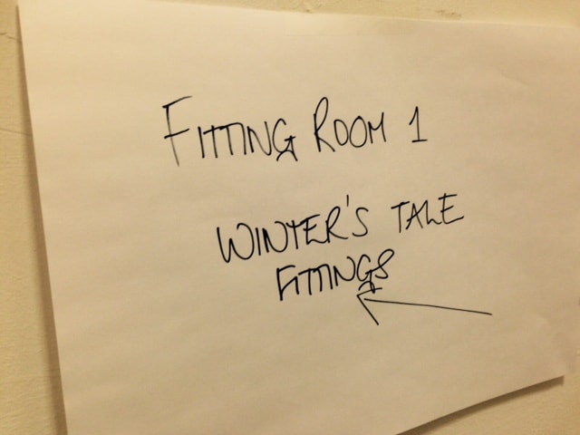 hand written sign reading fitting room 1 winter's tale fittings