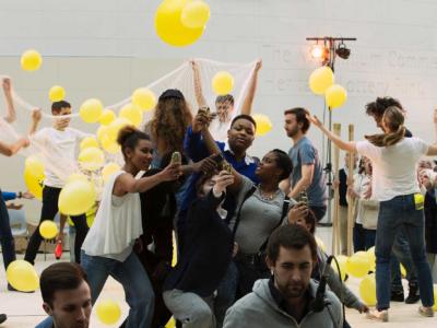 ENO Youth Programme participants perform with yellow balloons