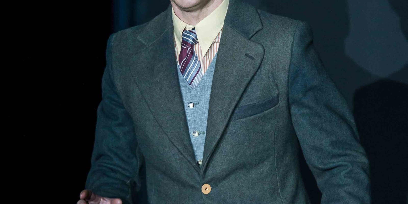 a man in a suit singing