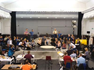 ENO chorus and cast on stage in the rehearsal room