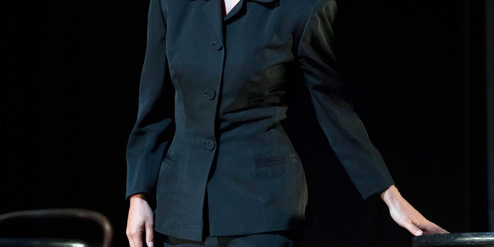a women in a tailored dark suit