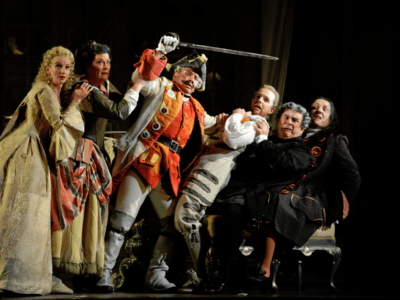 characters from Barber of Seville fighting on stage looking scared