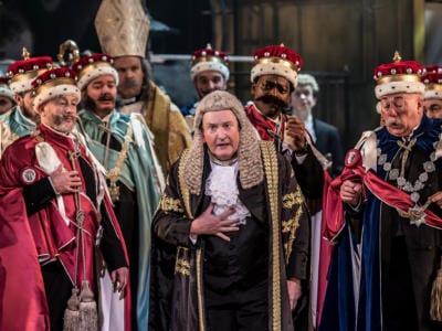 The Lord Chancellor in Iolanthe surrounded by chorus members