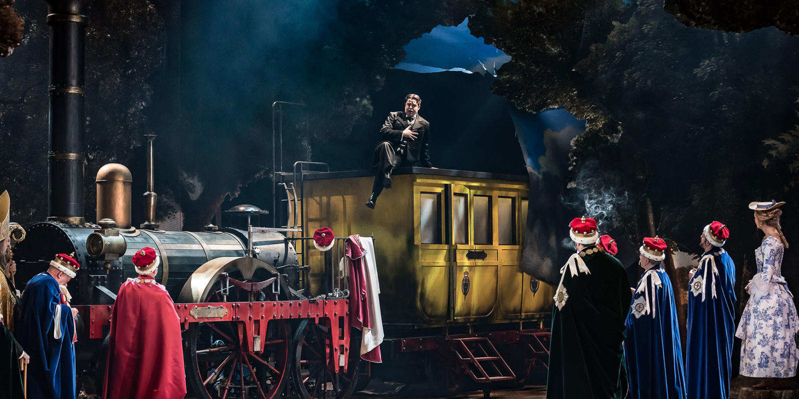 a man sat on top of a train singing