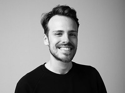 Pablo Strong smiling to camera against a grey background