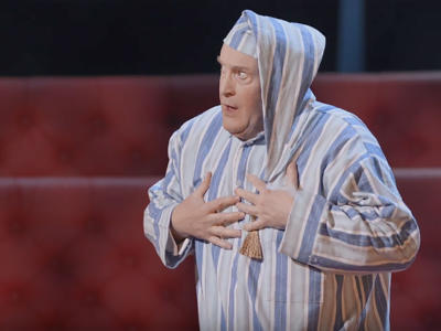 a man in blue and white pajamas looking shocked