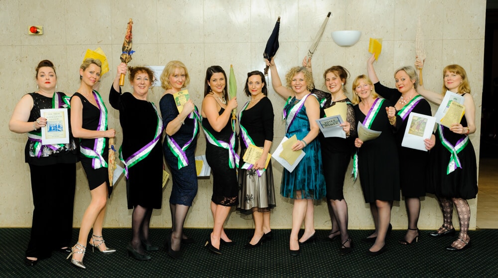 Female ENO Chorus holding umbrellas while posing for a picture at ENO's Gala Dinner