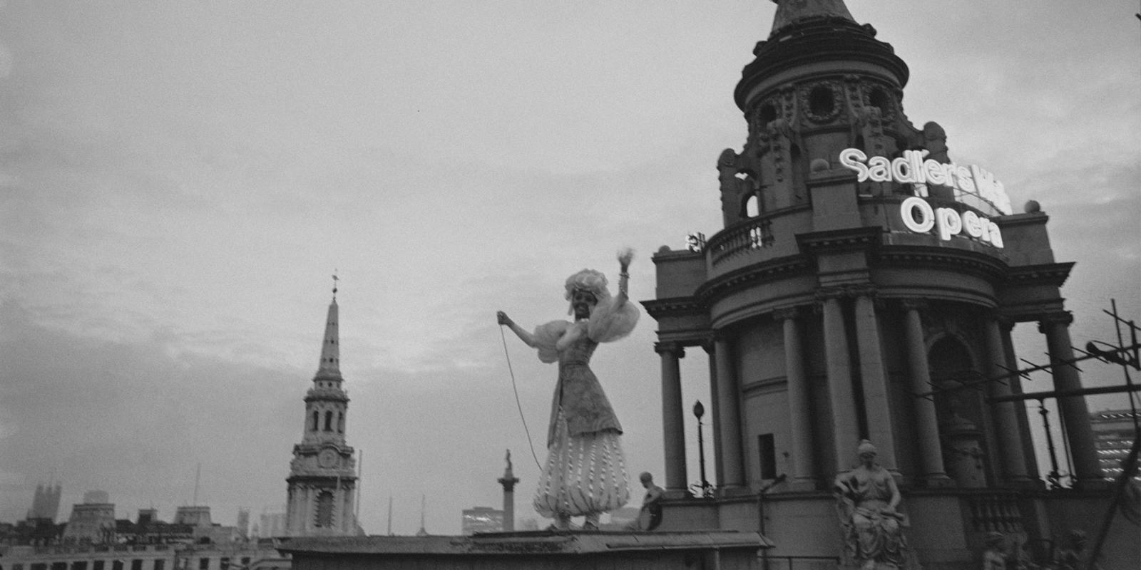 Ballet dancer Susan Hunt lights up London Coliseum's globe after repairs, 1968 (c) Maher/Stringer