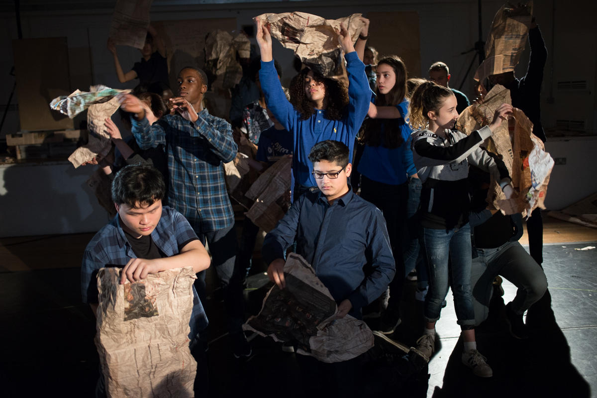 Young people exploring movement with newspaper as part of ENO's youth programme