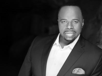 Lester Lynch wearing a suit looking to camera