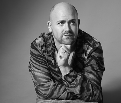 Nicky Spence resting his head on his hand