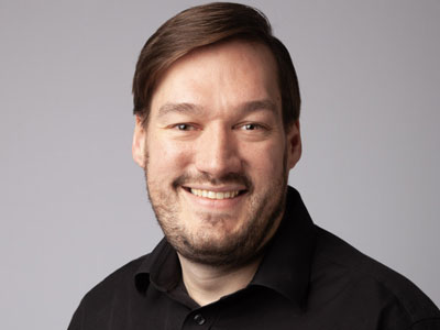 Headshot of David Spencer smiling to camera