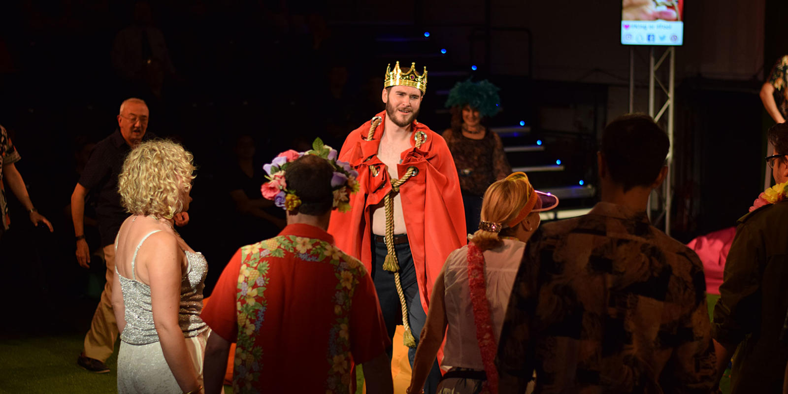 a man in a crown and cape
