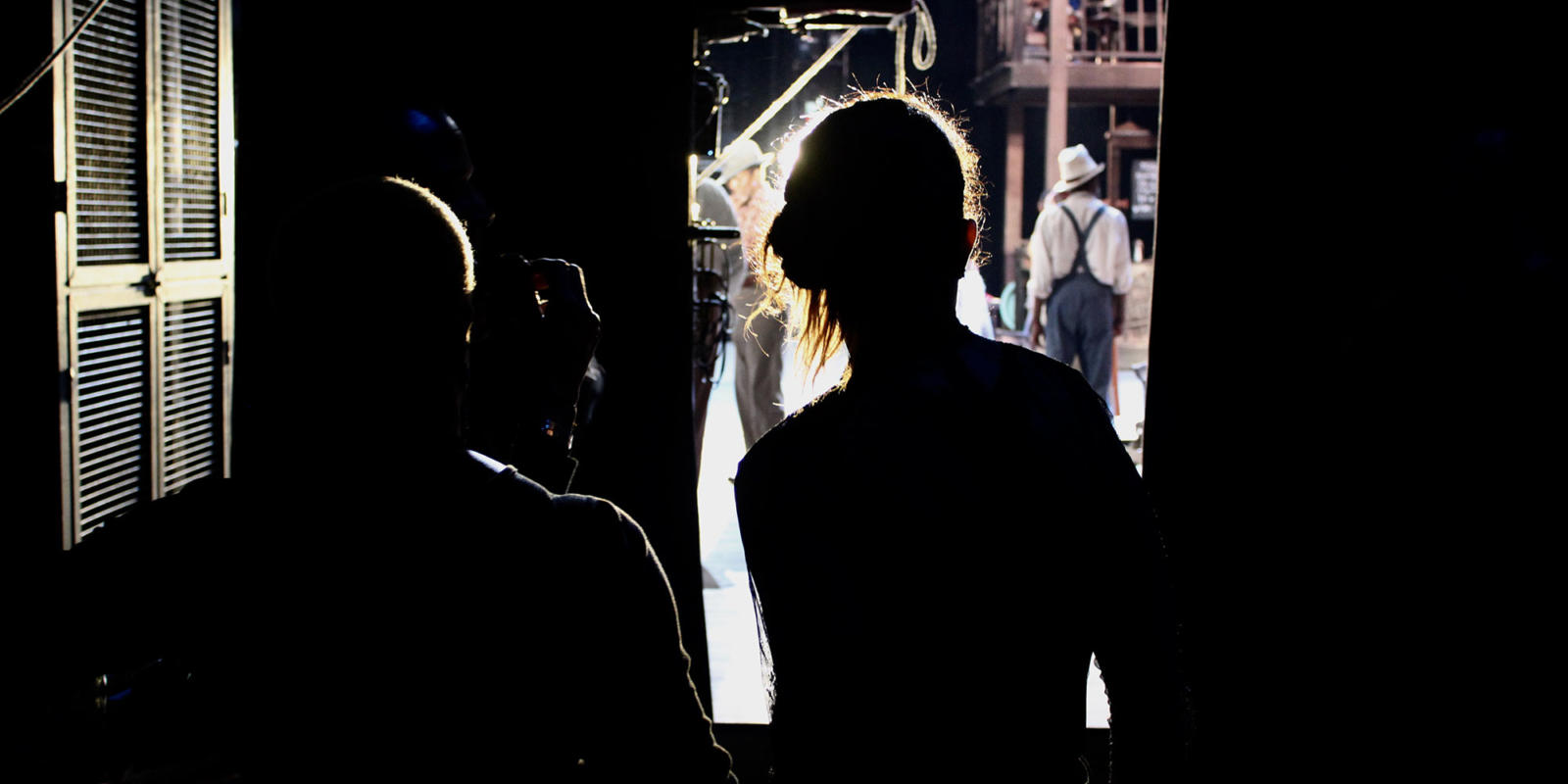 Members of the Stage Management Team look on at the performance from the wings